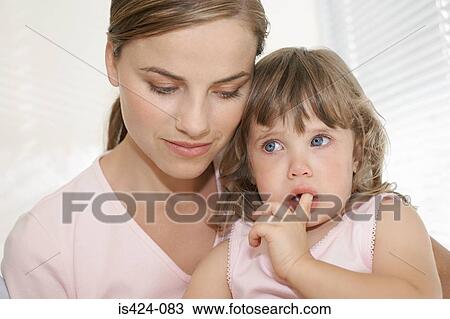 Stock Image - Mother comforting her daughter. Fotosearch