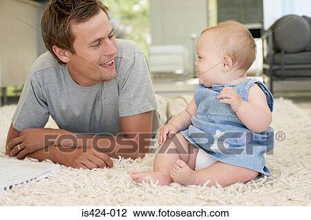 Stock Image - Portrait of a father with baby daughter. Fotosearch