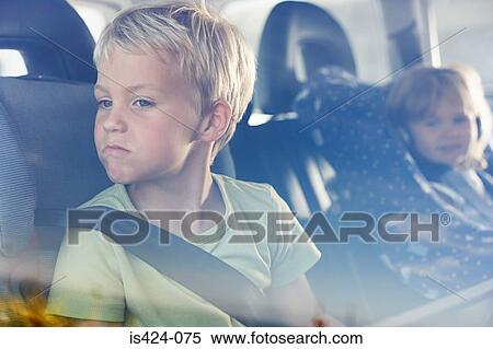 Stock Photography - Two children sat in the back of car. Fotosearch