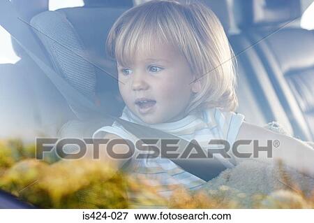 Young girl looking out of car window View Large Photo Image Stock Photo - Young girl looking out of car window. Fotosearch