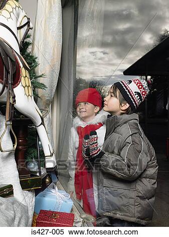 Stock Photography - Brother and sister christmas shopping. Fotosearch