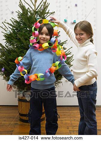 Brother and sister decorating christmas tree View Large Photo Image Picture - Brother and sister decorating christmas tree. Fotosearch