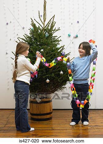 Brother and sister decorating christmas tree View Large Photo Image Stock Image - Brother and sister decorating christmas tree. Fotosearch