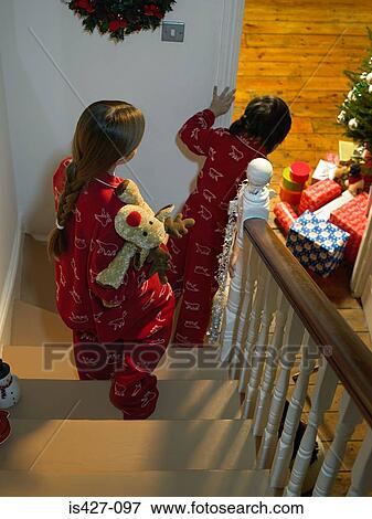 Stock Photo - Children walking downstairs on christmas eve. Fotosearch