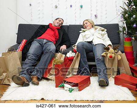 Couple exhausted after christmas shopping View Large Photo Image Stock Image - Couple exhausted after christmas shopping. Fotosearch