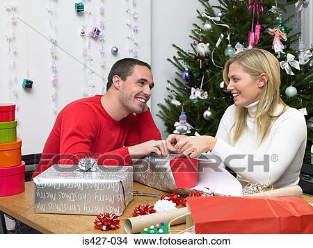 Couple wrapping christmas presents View Large Photo Image Picture - Couple wrapping christmas presents. Fotosearch