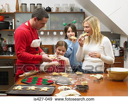 Stock Photo - Family eating gingerbread men. Fotosearch