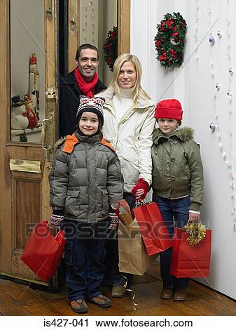 Family returning home from christmas shopping View Large Photo Image Stock Image - Family returning home from christmas shopping. Fotosearch