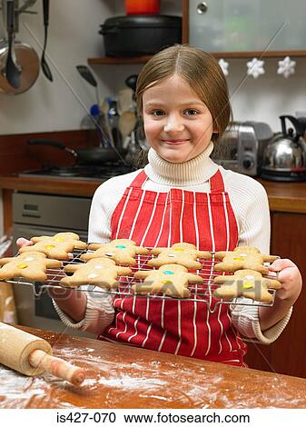 Stock Image - Girl with gingerbread men. Fotosearch