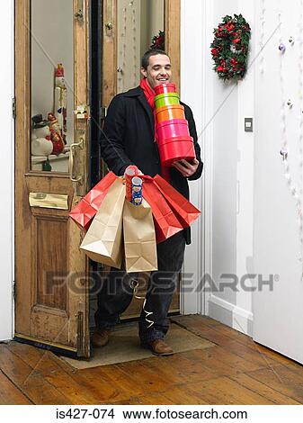 Man returning home from christmas shopping View Large Photo Image Picture - Man returning home from christmas shopping. Fotosearch