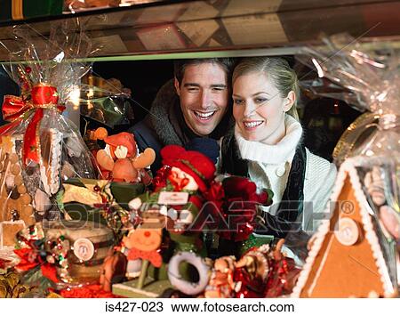 Mid adult couple christmas shopping View Large Photo Image Stock Image - Mid adult couple christmas shopping. Fotosearch