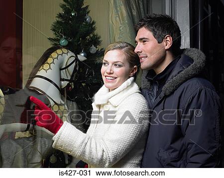 Mid adult couple christmas shopping View Large Photo Image Stock Image - Mid adult couple christmas shopping. Fotosearch