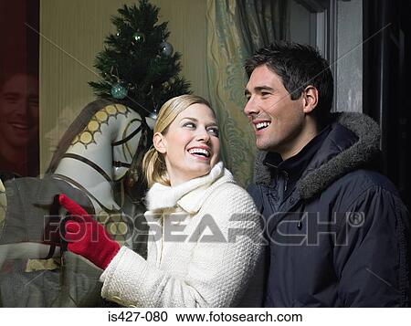 Mid adult couple christmas shopping View Large Photo Image Stock Image - Mid adult couple christmas shopping. Fotosearch