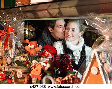 Stock Photo - Mid adult couple christmas shopping. Fotosearch