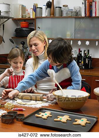 Mother and children making cookies View Large Photo Image Stock Image - Mother and children making cookies. Fotosearch
