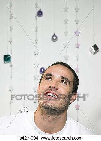 Picture - Portrait of a man with christmas decorations. Fotosearch