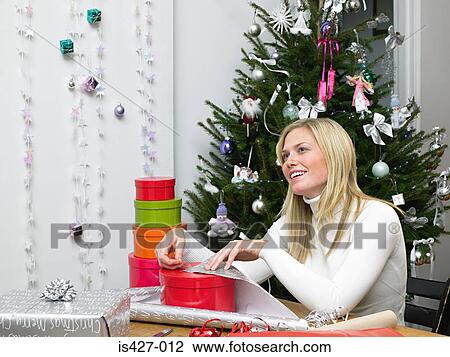 Stock Image - Woman wrapping christmas gifts. Fotosearch