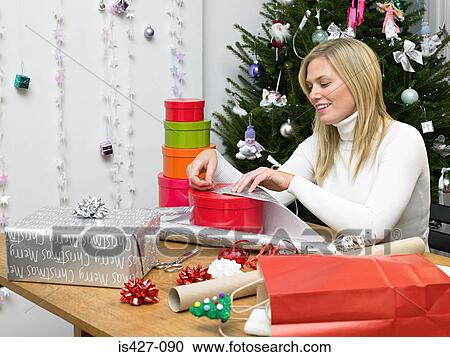 Woman wrapping christmas gifts View Large Photo Image Stock Image - Woman wrapping christmas gifts. Fotosearch