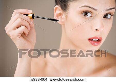 Picture - Girl applying mascara. Fotosearch