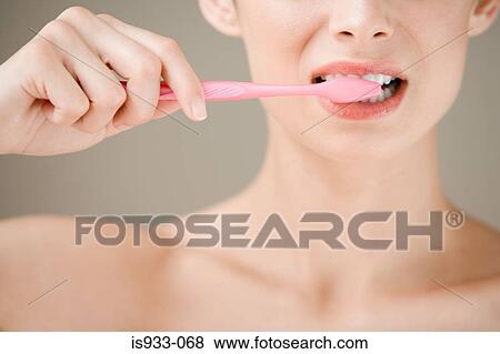 Stock Photo - Girl brushing teeth. Fotosearch