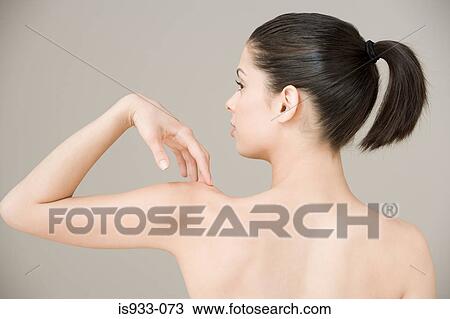 Girl touching her shoulder View Large Photo Image Stock Image - Girl touching her shoulder. Fotosearch