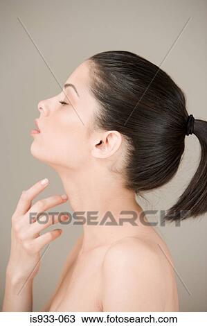 Woman touching her neck View Large Photo Image Stock Image - Woman touching her neck. Fotosearch