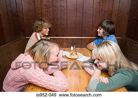 Four teenagers in a cafe View Large Photo Image Stock Photo - Four teenagers in a cafe. Fotosearch