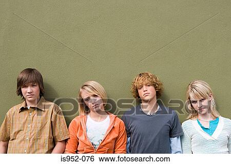 Four teenagers leaning against wall View Large Photo Image Stock Photograph - Four teenagers leaning against wall. Fotosearch