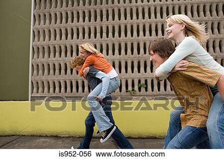 Four teenagers running piggy back races View Large Photo Image Stock Photograph - Four teenagers running piggy back races. Fotosearch