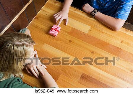 Teenage boy giving girl a present View Large Photo Image Stock Photography - Teenage boy giving girl a present. Fotosearch