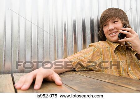 Stock Photography - Teenage boy talking on a cellular phone. Fotosearch