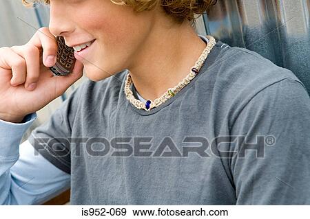 Teenage boy talking on phone View Large Photo Image Stock Photo - Teenage boy talking on phone. Fotosearch