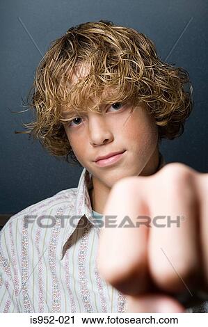 Stock Image - Teenage boy with fist clenched. Fotosearch