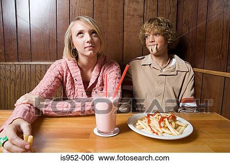 Stock Photograph - Teenage couple in a cafe. Fotosearch
