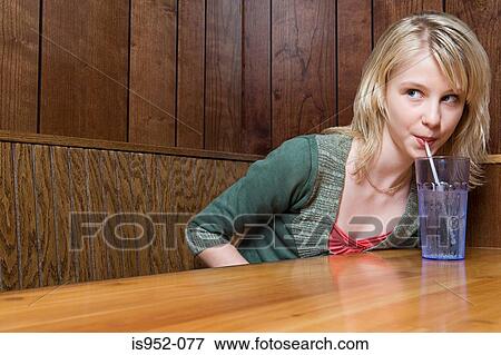 Teenage girl drinking soda in a cafe View Large Photo Image Stock Photo - Teenage girl drinking soda in a cafe. Fotosearch