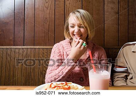 Stock Image - Teenage girl in a cafe. Fotosearch