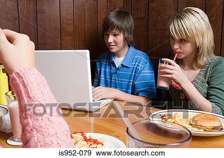 Three teenagers at a cafe View Large Photo Image Stock Photo - Three teenagers at a cafe. Fotosearch