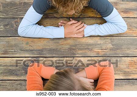 Two teenagers sat facing each other View Large Photo Image Stock Image - Two teenagers sat facing each other. Fotosearch