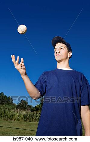 Teenage boy throwing baseball in the air View Large Photo Image Stock Image - Teenage boy throwing baseball in the air. Fotosearch