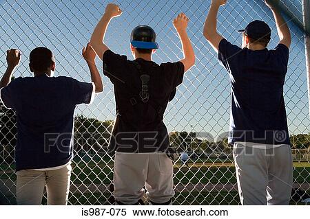 Stock Photography - Three teenagers watching from the sidelines. Fotosearch