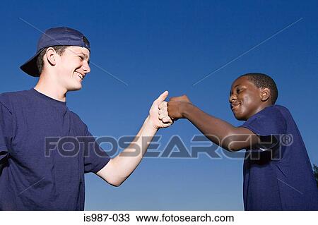 Stock Image - Two teenage boys celebrating. Fotosearch