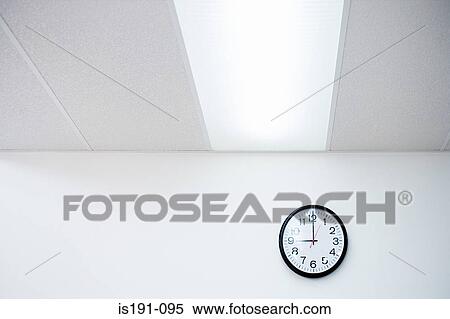 Stock Photography - Clock on an office wall. Fotosearch