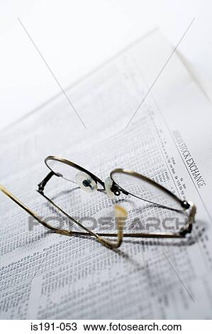 Stock Image - Glasses on financial pages. Fotosearch