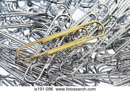 Stock Photograph - Golden paperclip amongst silver paperclips. Fotosearch