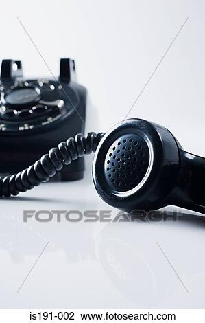 Stock Image - Telephone handset off the hook. Fotosearch