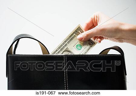 Woman taking a dollar from handbag View Large Photo Image Stock Photo - Woman taking a dollar from handbag. Fotosearch