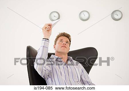 Businessman about to throw paper aeroplane View Large Photo Image Stock Photography - Businessman about to throw paper aeroplane. Fotosearch