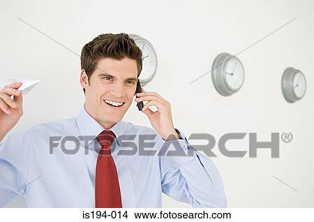 Picture - Businessman getting good news on the telephone. Fotosearch