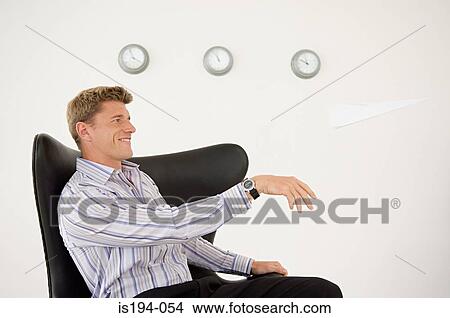 Businessman throwing a paper aeroplane View Large Photo Image Picture - Businessman throwing a paper aeroplane. Fotosearch