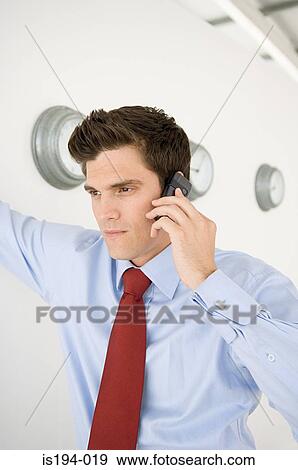Stock Photo - Businessman using cellular telephone. Fotosearch